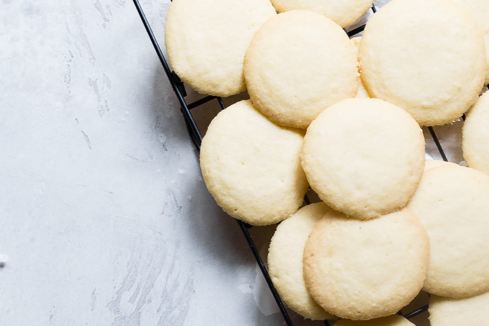 cooling rack of round coconut shortbread cookies on a counter