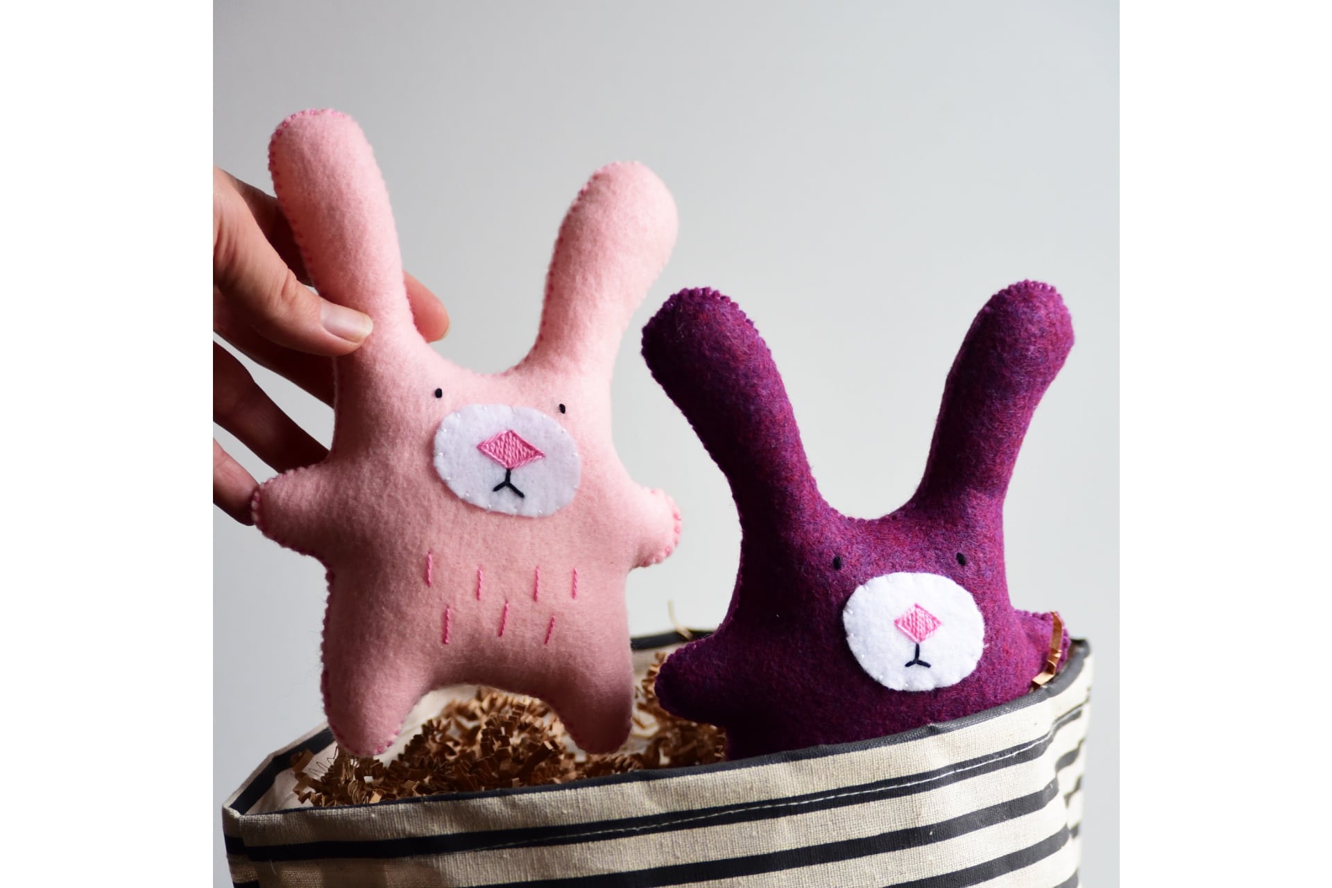 two felted bunnies in pink and purple
