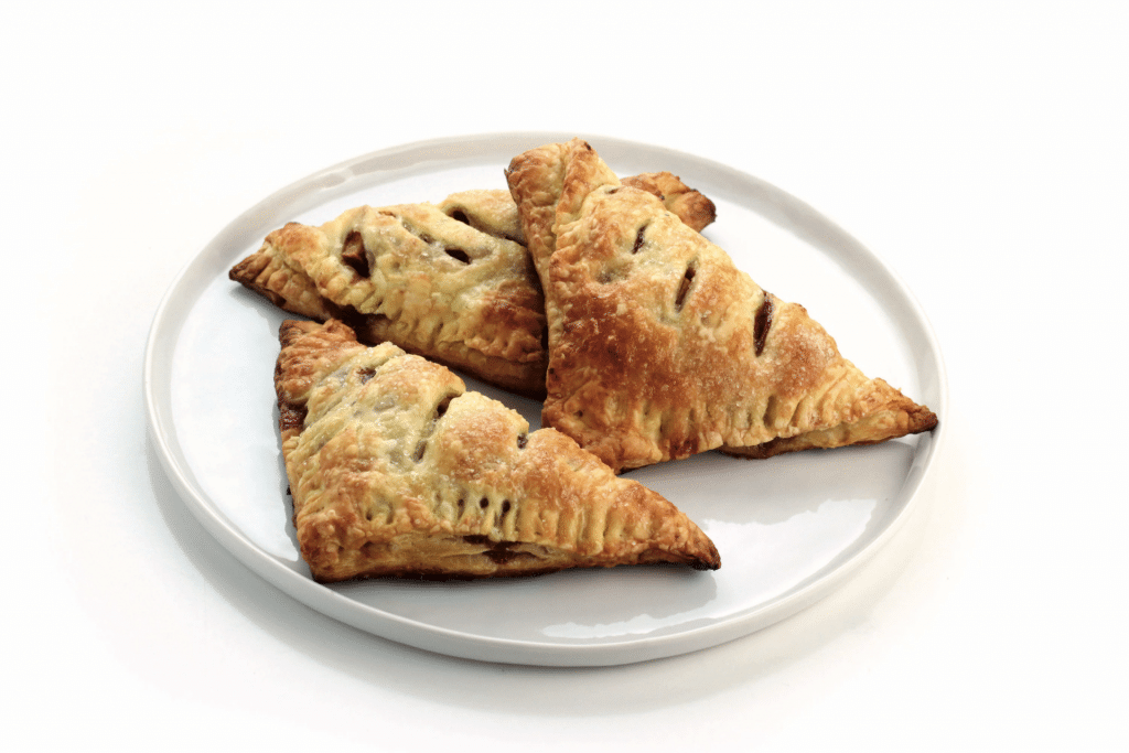 plate of apple turnovers on white background
