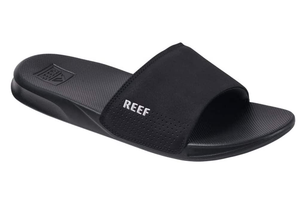 black slide sandals that say Reef