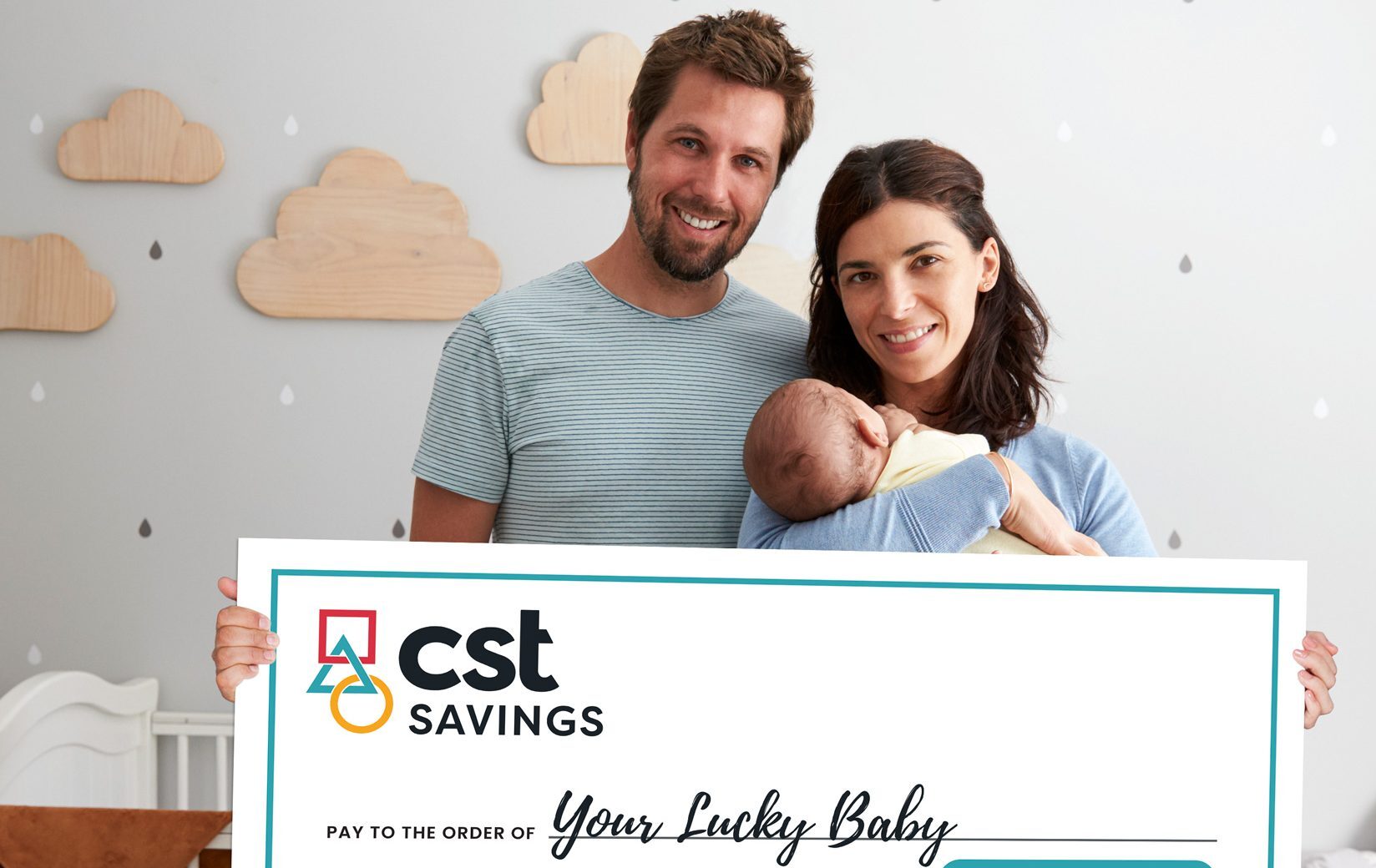 New parents with baby holding cheque for $5000