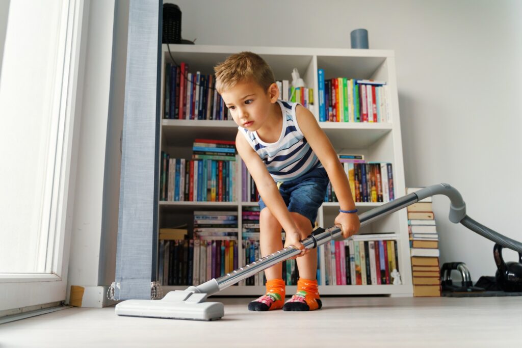 Should You Pay Your Kids for Chores? A child vacuums