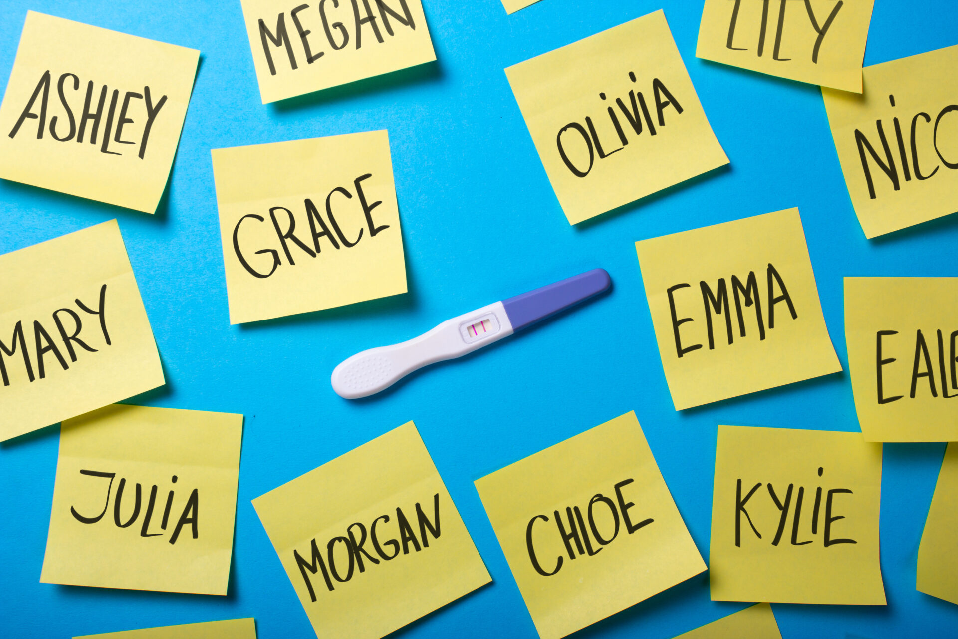 Celebrity baby names on Post-its around pregnancy test