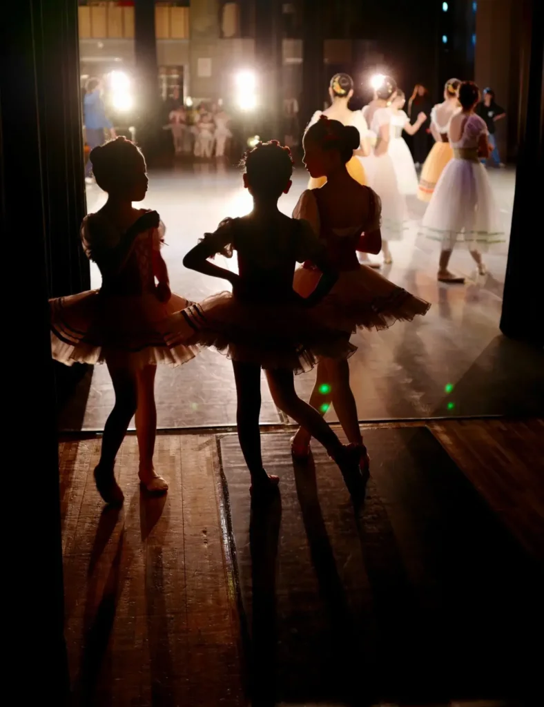 a group of girls in tutu skirts and dancing