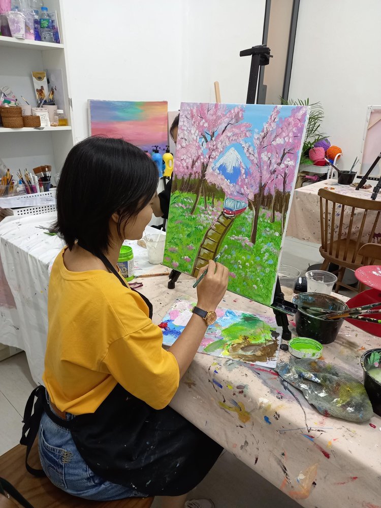 girl painting on canvas