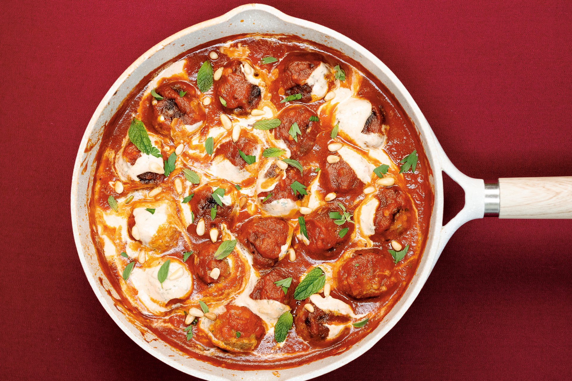 Skillet with saucy lamb meatballs