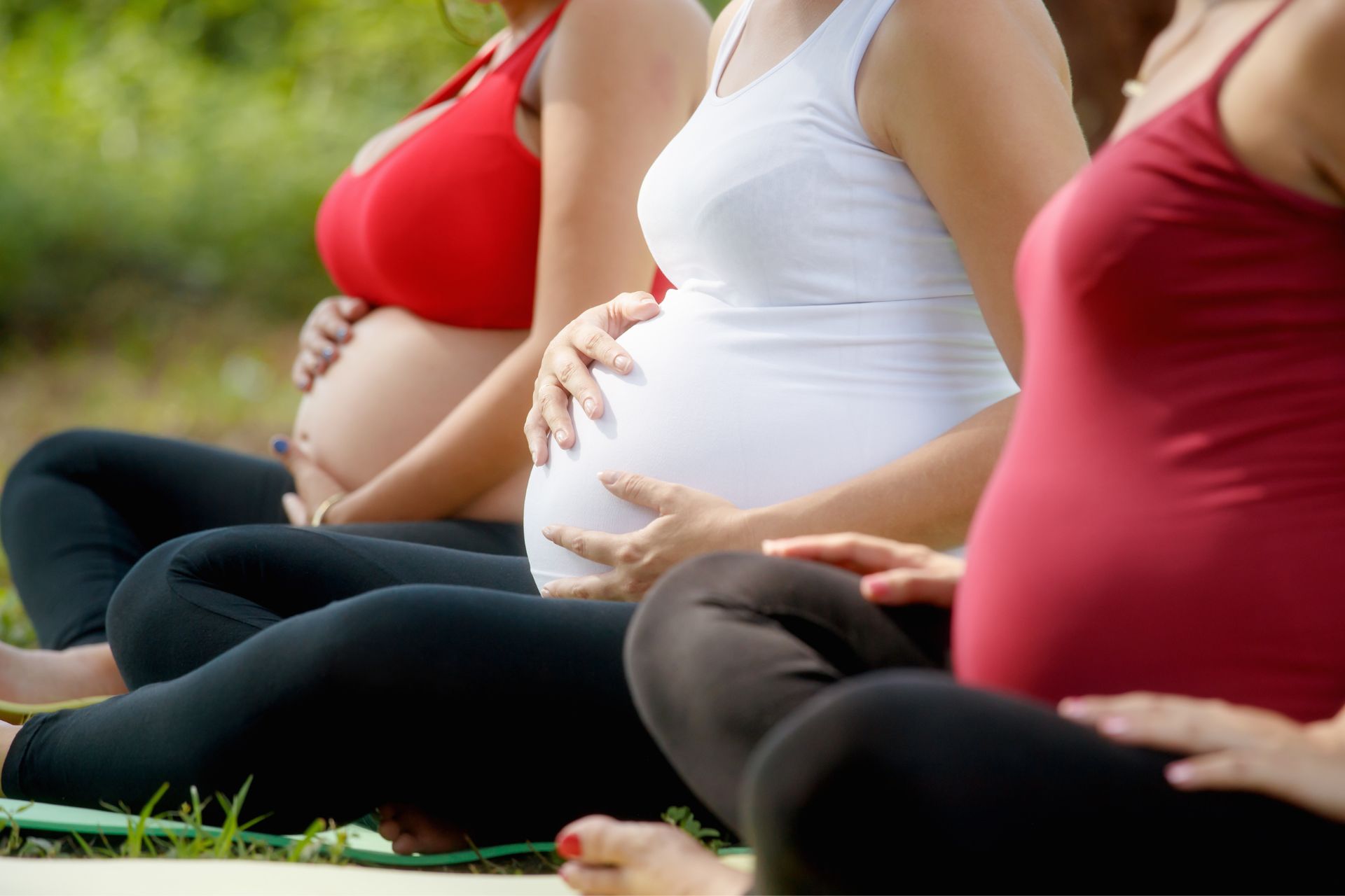 a group of pregnant women sitting on the ground